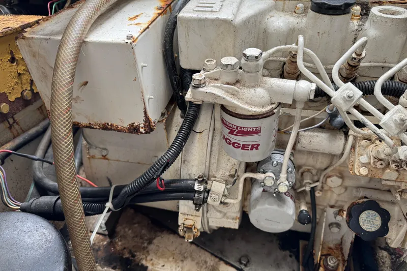 Slide: The Image of Engine compartment of a 1993 Blackfin Sportfisher boat, showing mechanical components and wiring. - 60