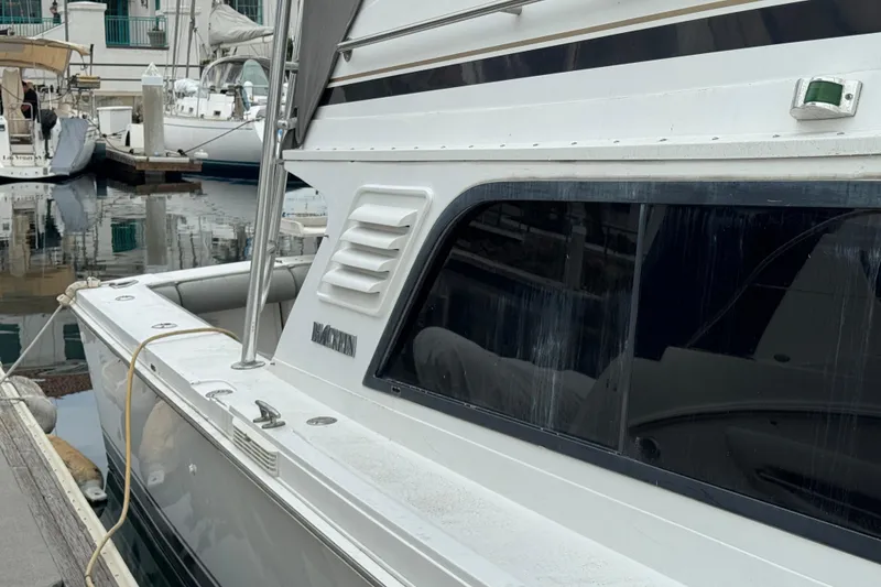 Slide: The Image of 1993 Blackfin Sportfisher boat docked at a marina, side view. - 7