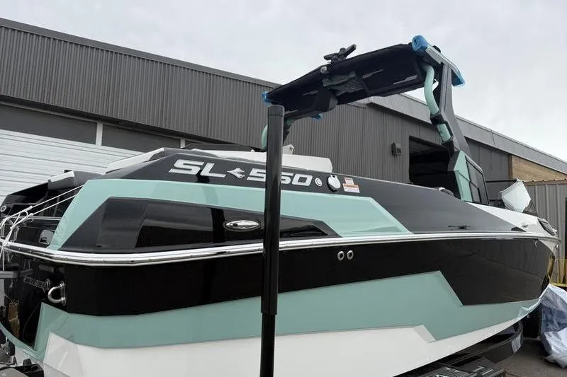Slide: The Image of 2025 Supra SL 575 boat in a storage facility, showcasing sleek design and modern features. - 1