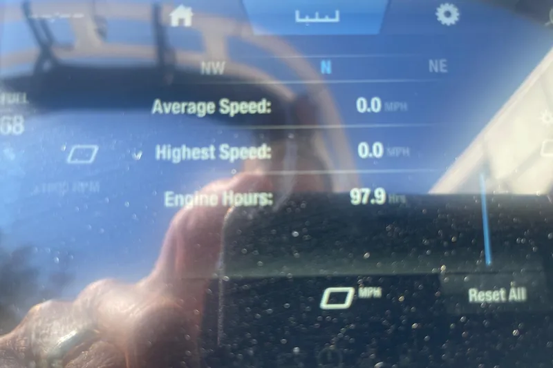 Slide: The Image of Dashboard of 2023 Yamaha Boats AR195 showing engine hours at 97.9. - 13