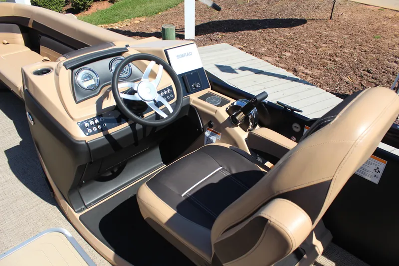 Slide: The Image of 2025 Barletta C24UC boat interior with steering wheel and control panel. - 12