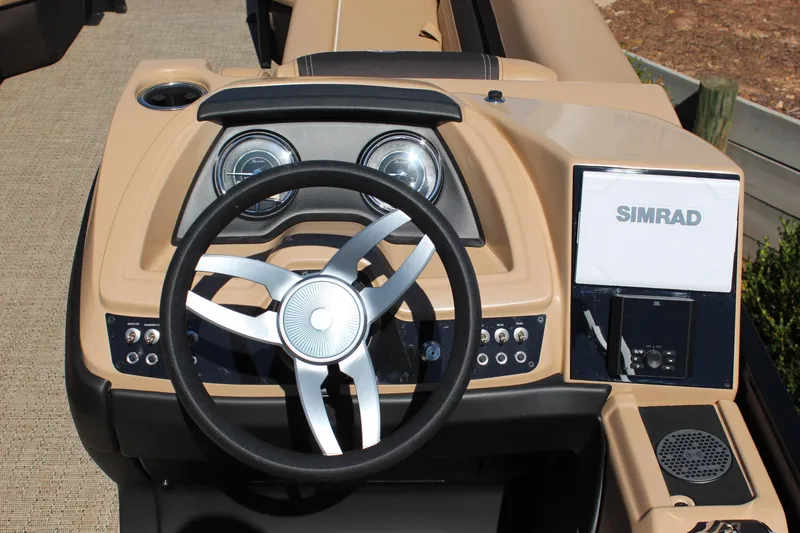 Slide: The Image of 2025 Barletta C24UC boat dashboard with steering wheel and Simrad display. - 13