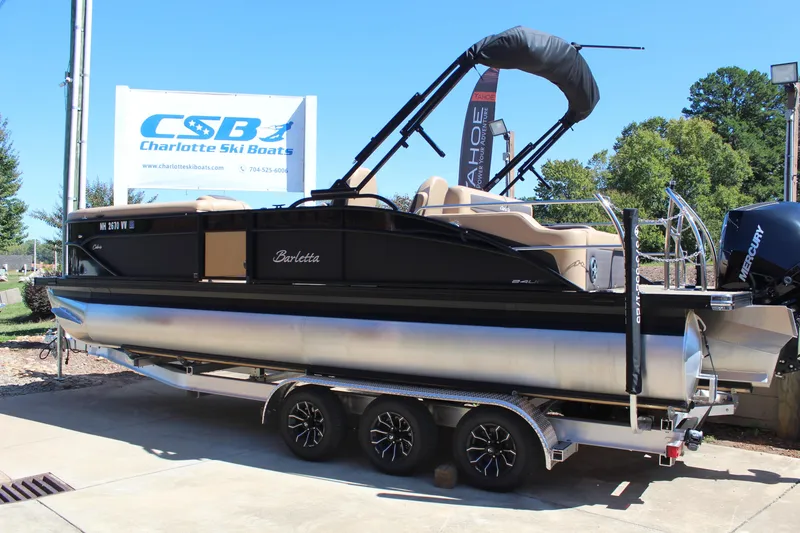 Slide: The Image of 2025 Barletta C24UC pontoon boat on trailer at Charlotte Ski Boats dealership. - 3