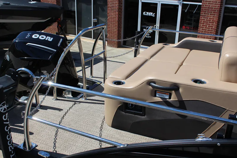 Slide: The Image of 2025 Barletta C24UC pontoon boat with tan seating and powerful outboard motor. - 6