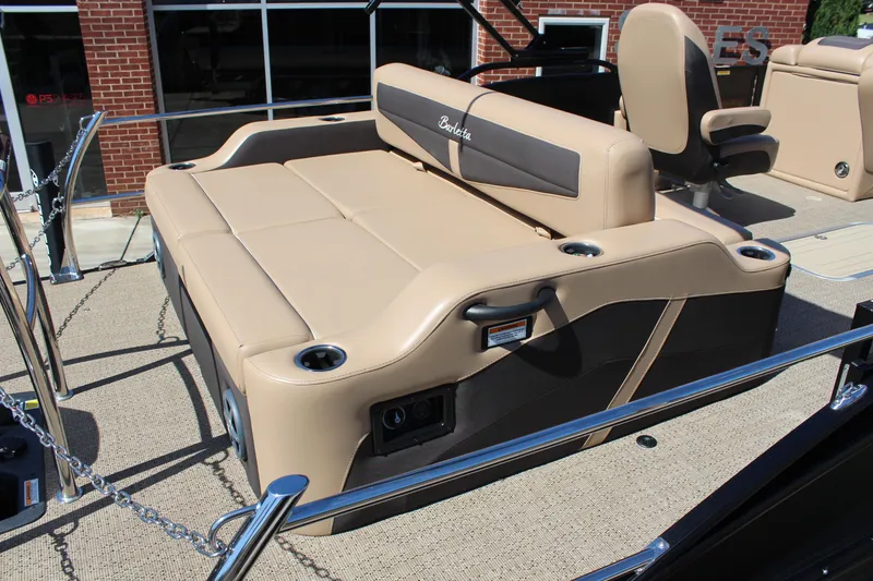 Slide: The Image of 2025 Barletta C24UC boat interior with beige seating and cup holders. - 7