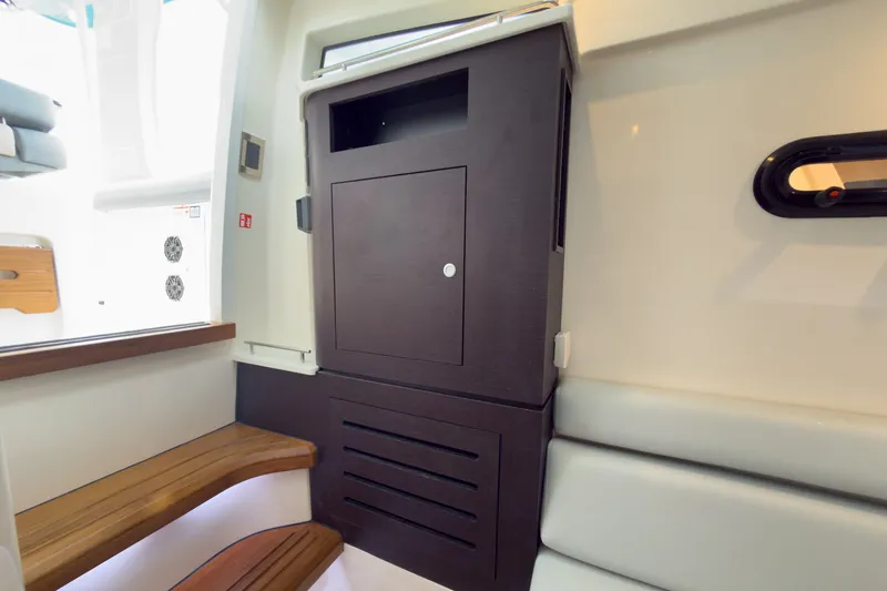 Slide: The Image of Interior of a modern cabin with wooden benches and a dark cabinet. - 22