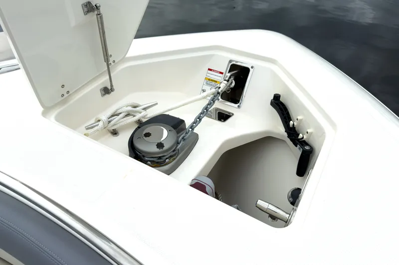 Slide: The Image of The bow area of a 2026 Boston Whaler 350 Realm features an anchor and storage space. - 25