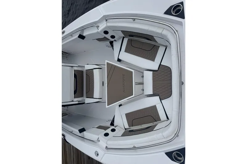 Slide: The Image of 2025 Blackfin 272CC boat interior with cushioned seating and sleek design. - 4