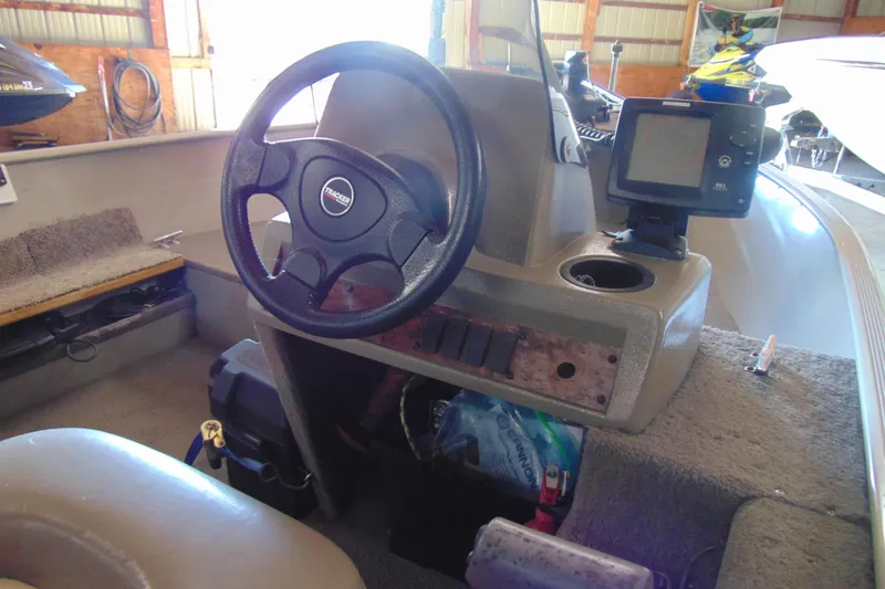 Slide: The Image of 2002 Tracker Super Guide V-15 boat interior with steering wheel and control panel. - 5