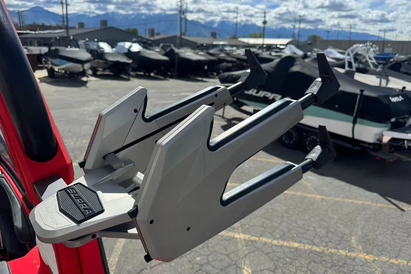 Slide: The Image of Close-up of 2025 Supra SL 575 boat accessory with covered boats in the background. - 11
