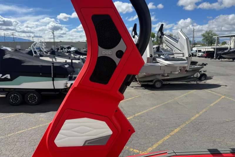 Slide: The Image of Red speaker system on 2025 Supra SL 575 boat, with covered boats in background. - 14