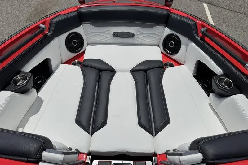 Slide: The Image of 2025 Supra SL 575 boat interior with luxurious black and white seating and integrated speakers. - 8