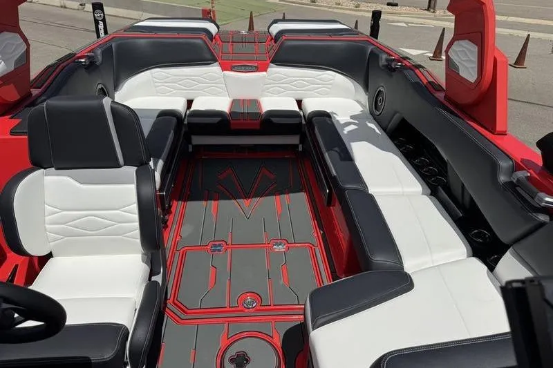 Slide: The Image of 2025 Supra SL 575 boat interior with sleek black and white seating, red accents. - 9