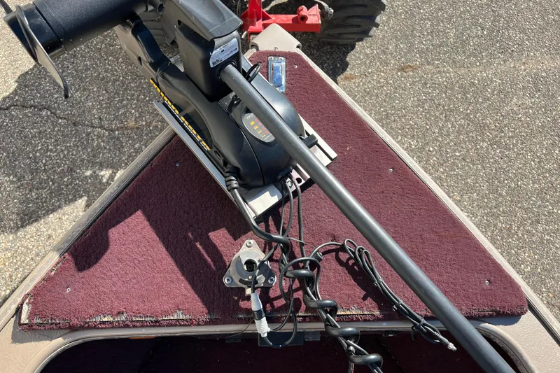 Slide: The Image of 1996 Lund 1800 Pro-V SE boat with trolling motor on maroon carpeted deck. - 9