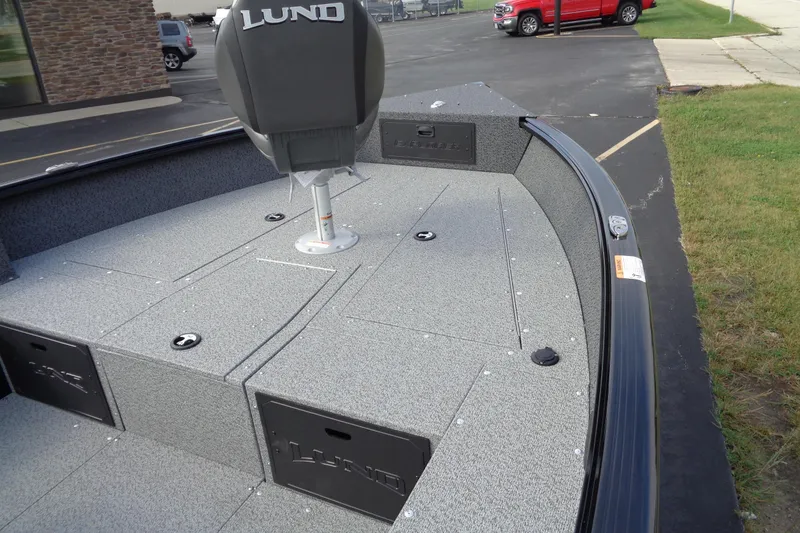 Slide: The Image of 2026 Lund 1800 Explorer Tiller boat interior with seating and storage compartments. - 14