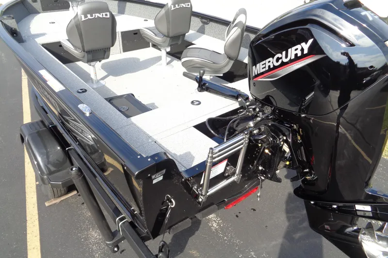Slide: The Image of 2026 Lund 1800 Explorer Tiller boat with Mercury engine, featuring spacious seating and sleek design. - 17