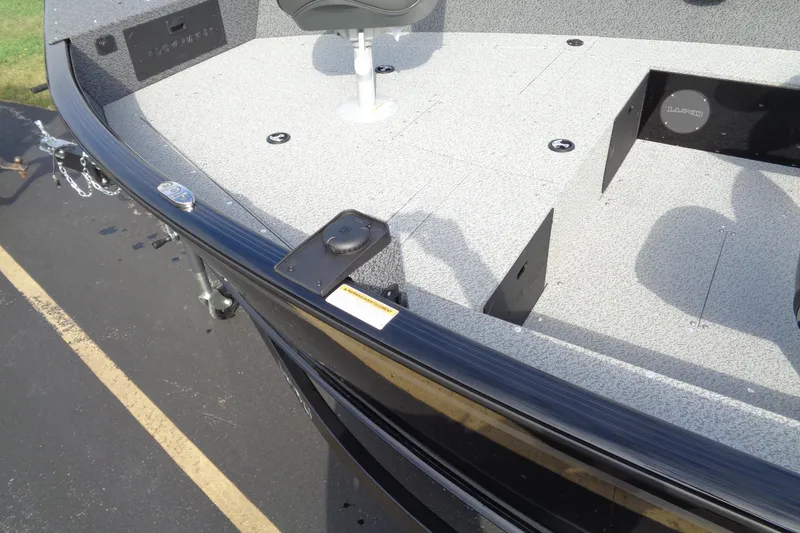 Slide: The Image of 2026 Lund 1800 Explorer Tiller boat interior with seating and storage compartments. - 5