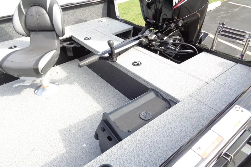 Slide: The Image of 2026 Lund 1800 Explorer Tiller boat interior with seating and motor controls. - 8