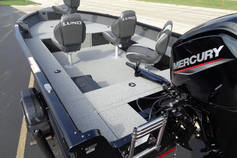 Slide: The Image of 2026 Lund 1800 Explorer Tiller boat with Mercury engine, featuring spacious seating and modern design. - 9