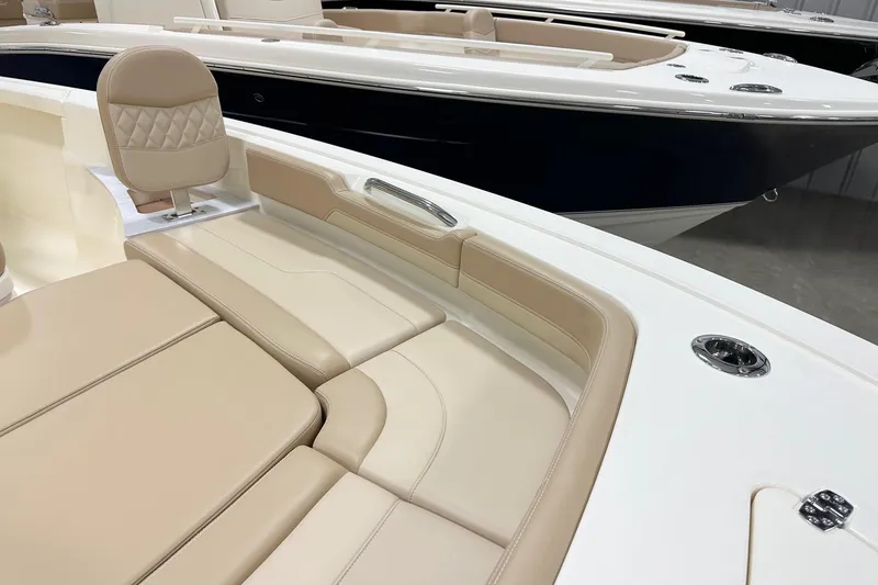 Slide: The Image of 2026 Scout 261 XSS boat interior with beige seating and sleek design. - 10