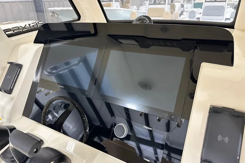 Slide: The Image of 2026 Scout 261 XSS boat dashboard with dual Garmin displays and Fusion audio system. - 4