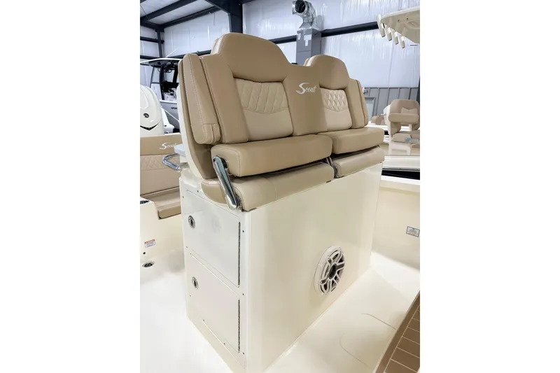 Slide: The Image of 2026 Scout 261 XSS boat interior with beige cushioned seating and storage compartments. - 5