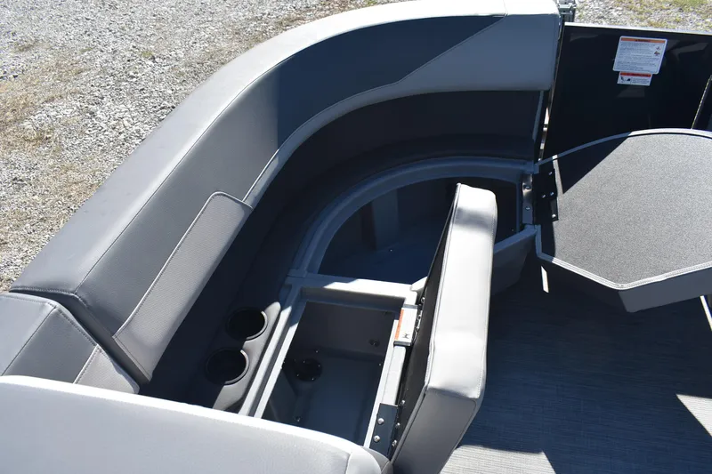 Slide: The Image of 2026 Lowe LS 170 boat interior with open storage compartment and cup holders. - 12
