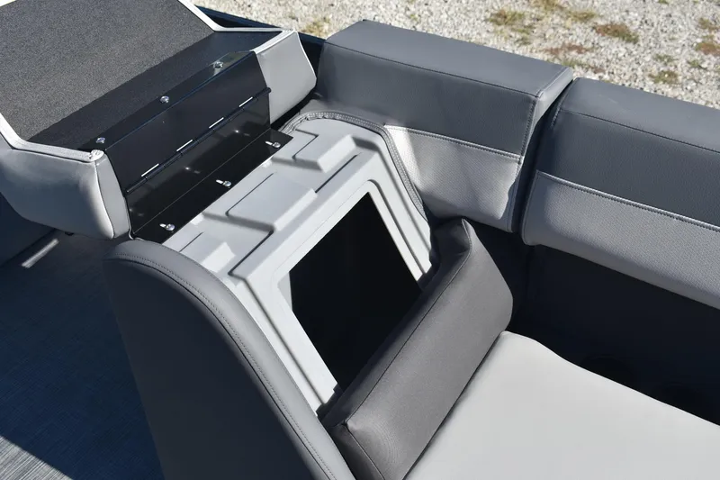 Slide: The Image of Interior of 2026 Lowe LS 170 boat with open storage compartment and cushioned seating. - 13