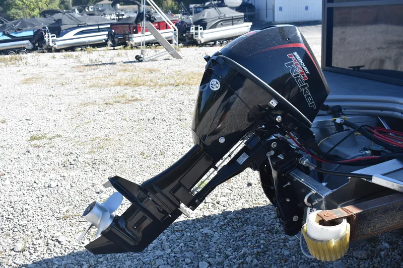 Slide: The Image of Outboard motor on Lowe LS 170 boat, 2026 model, in a gravel lot with other boats. - 5