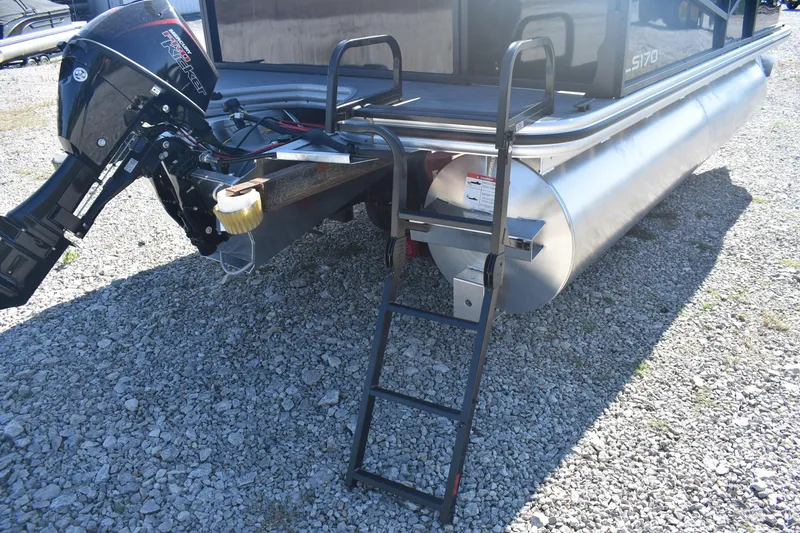 Slide: The Image of 2026 Lowe LS 170 boat with motor and ladder on gravel surface. - 6