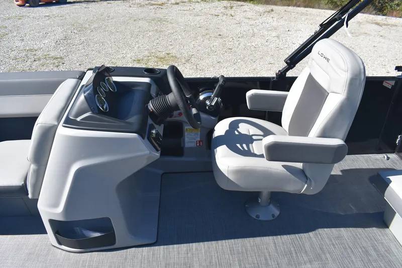 Slide: The Image of 2026 Lowe LS 170 boat interior with steering console and cushioned captain's chair. - 8