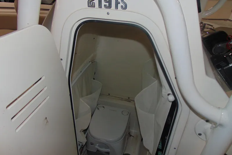 Slide: The Image of 2022 Key West 219 FS boat interior with compact marine toilet. - 11