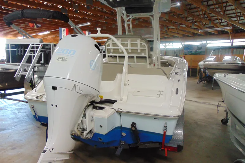 Slide: The Image of 2022 Key West 219 FS boat with outboard motor in a showroom. - 2