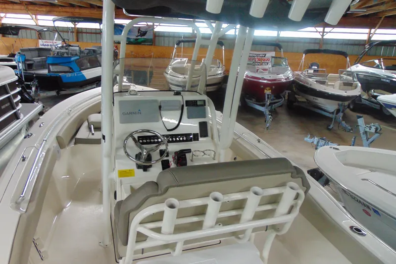 Slide: The Image of 2022 Key West 219 FS boat interior with steering console in a showroom. - 4