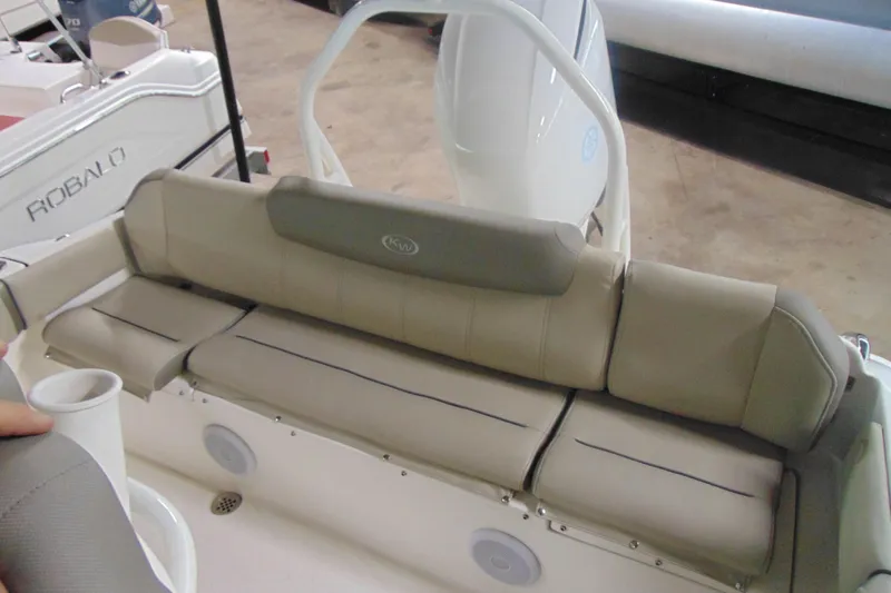 Slide: The Image of 2022 Key West 219 FS boat interior with beige cushioned seating and cup holder. - 5