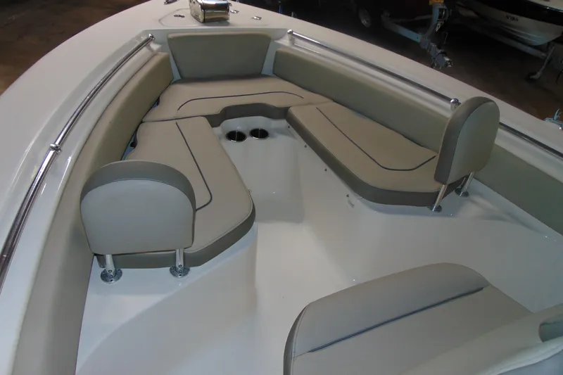 Slide: The Image of 2022 Key West 219 FS boat interior with cushioned seating and cup holders. - 8
