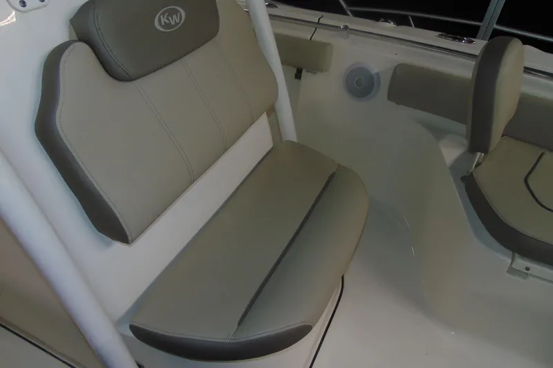 Slide: The Image of 2022 Key West 219 FS boat interior seating with beige cushions and speaker. - 9