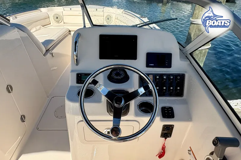 Slide: The Image of 2018 Grady-White Freedom 215 boat dashboard with steering wheel and controls. - 10