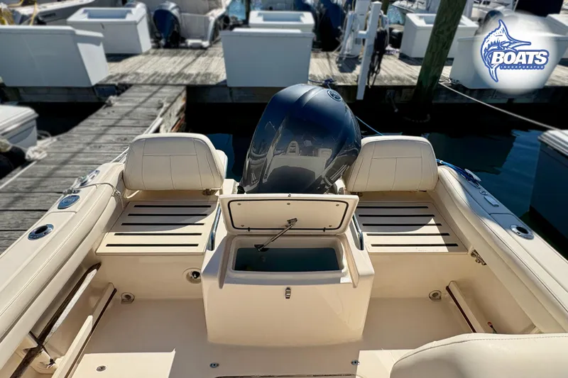Slide: The Image of 2018 Grady-White Freedom 215 boat interior with open storage, docked at marina. - 12