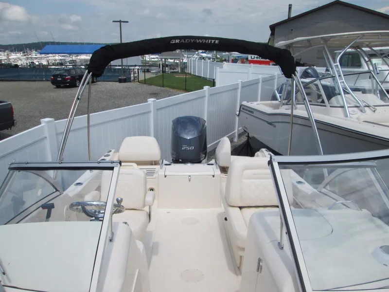 Slide: The Image of 2018 Grady-White Freedom 215 boat with Yamaha 250 engine, docked in a marina. - 8