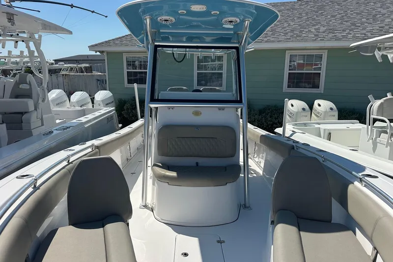 Slide: The Image of 2021 Sportsman Open 282 Center Console boat with seating and console, docked outdoors. - 6