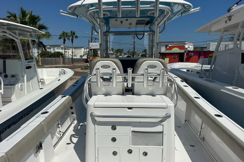 Slide: The Image of 2021 Sportsman Open 282 Center Console boat with dual seating and rod holders. - 9