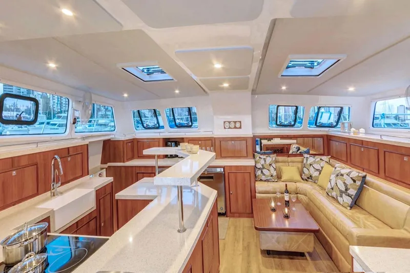 Slide: The Image of Luxurious interior of 2023 Royal Cape Catamarans Majestic 530 with modern kitchen and seating area. - 1