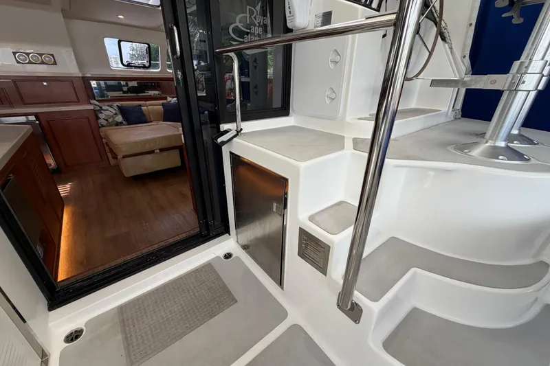 Slide: The Image of Interior view of 2023 Royal Cape Catamarans Majestic 530, featuring modern staircase and cozy seating area. - 10
