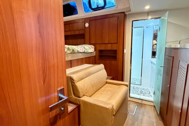 Slide: The Image of Luxurious interior of 2023 Royal Cape Catamarans Majestic 530, featuring wood finishes and cozy seating. - 100