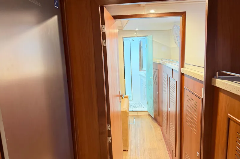 Slide: The Image of Interior hallway of 2023 Royal Cape Catamarans Majestic 530, featuring wooden finishes and modern design. - 101