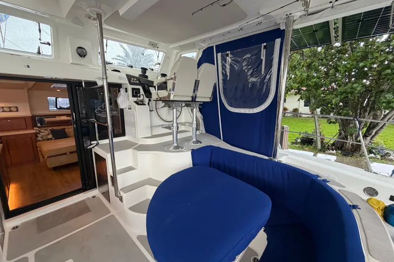 Slide: The Image of Interior view of 2023 Royal Cape Catamarans Majestic 530, featuring seating and helm station. - 103