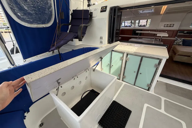 Slide: The Image of 2023 Royal Cape Catamarans Majestic 530 yacht interior with open storage and seating area. - 11