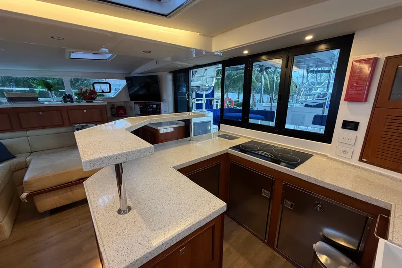 Slide: The Image of Luxurious interior of 2023 Royal Cape Catamarans Majestic 530 with modern kitchen and seating area. - 110
