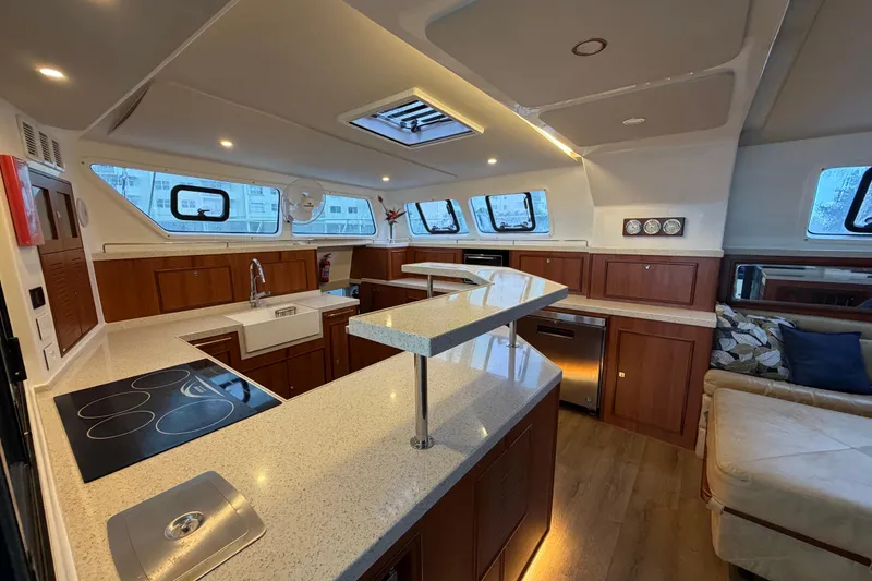Slide: The Image of Luxurious interior of 2023 Royal Cape Catamarans Majestic 530 with modern kitchen and seating area. - 114